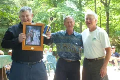 Three men standing side by side with smiles