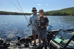 2026 bass tournament winners with the trophy in their boat