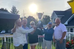 Shelley and team #1 hold up the tournament trophy in celebration.