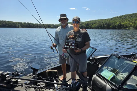 2026 bass tournament winners with the trophy in their boat