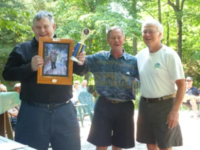 Three men standing side by side with smiles