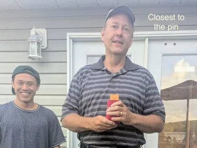 Closest to the pin: the winner holding his prize