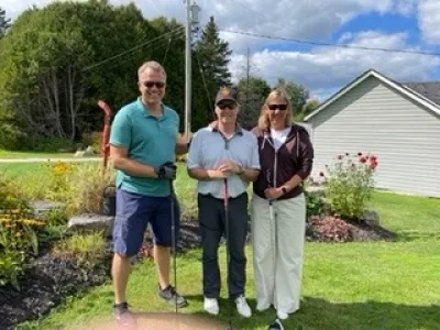 Team #4 made up of three golfers pose at the Lakeside Golf Course.