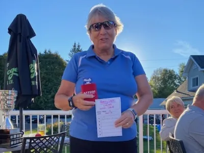 Diane Pearce, longest drive (women), holding her scorecard
