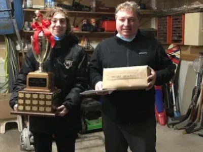 Julian Tilman holding the 2019 Bass Trophy