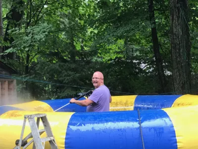 The Rave water trampoline being inflated on shore