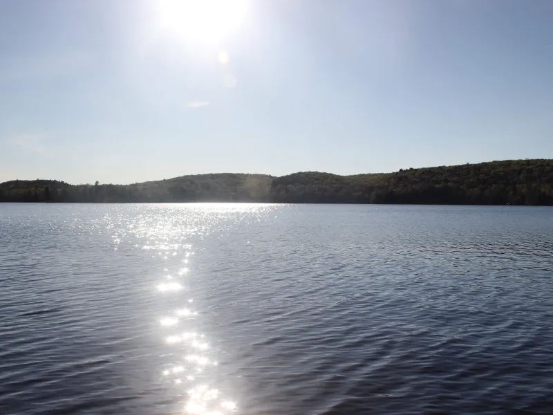 The sun leaves a line of shining water across Percy Lake.