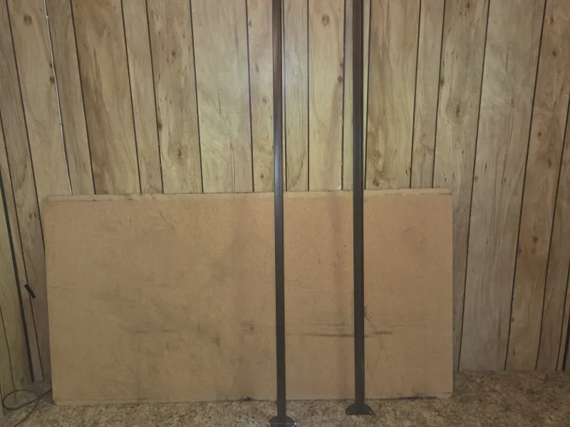 The bed rails and support board leaning against a wall