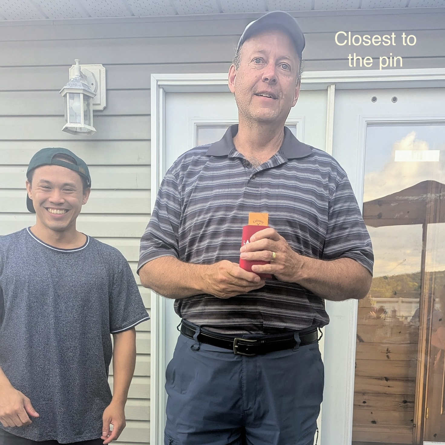 With dirnk in hand, Mike accepts the closest to pin award.