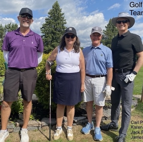 Four golfers that make up team 2 pose with clubs in hand.