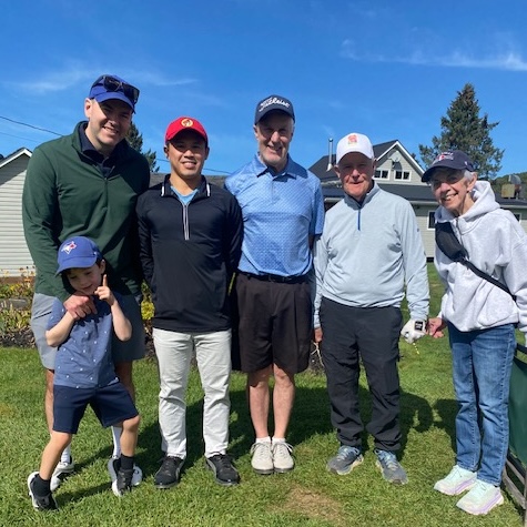 A group of five golfers and a child.